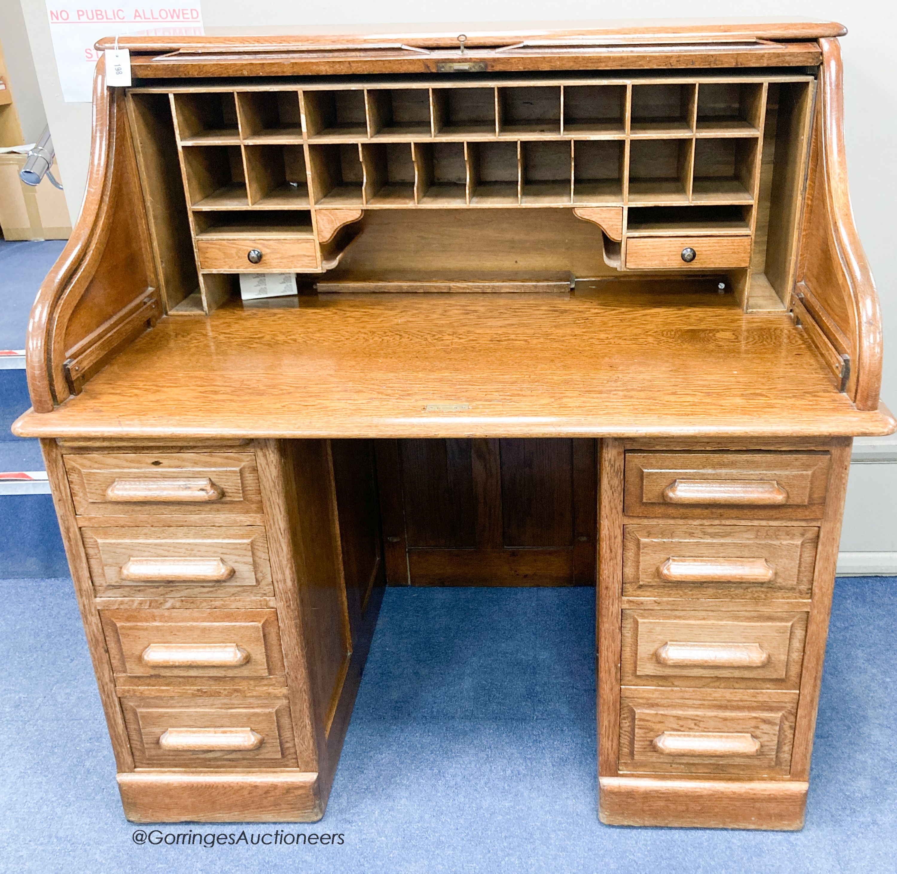 An early 20th century oak roll top desk with 'S' shaped tambour, width 120cm, depth 78cm, height of 124cm